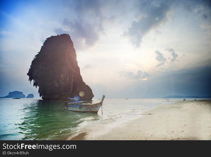 White Wooden Boat on Body of Water