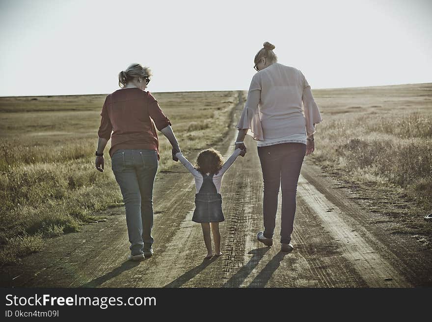 Photography of Women Walking on Dirt Road