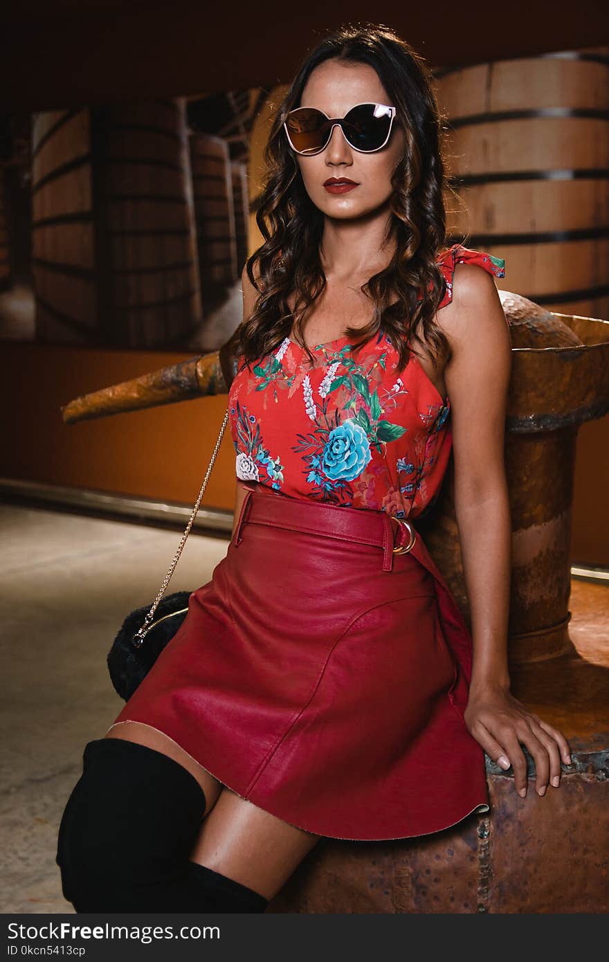 Photography of Woman Wearing Floral Top and Red Leather Skirt