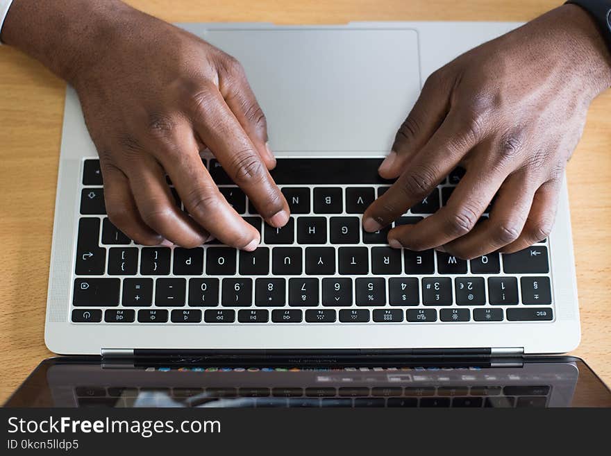 Person Typing on Laptop