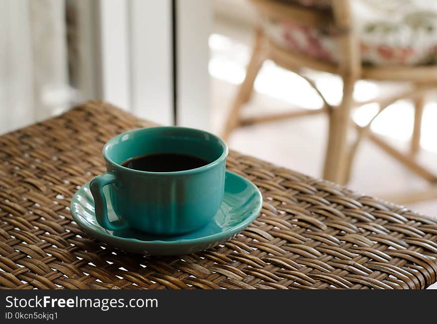 Blue Coffee Cup With Saucer Filled With Coffee on Top of Wicker Table