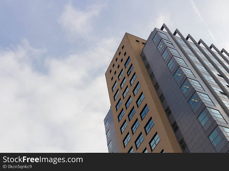 Worm&#x27;s-eye View of High Rise Building Under White Sky