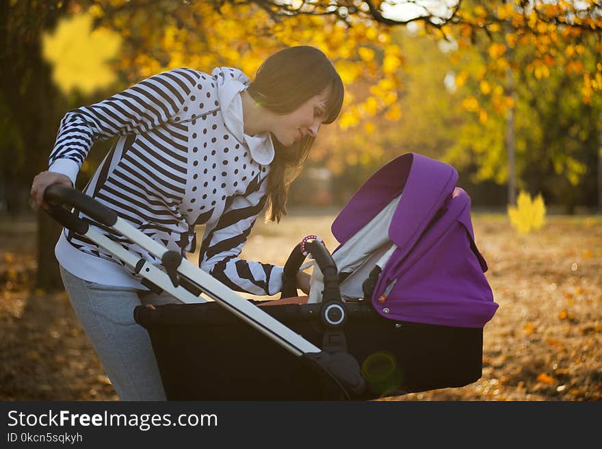 Photo of a Woman Looking Her Baby