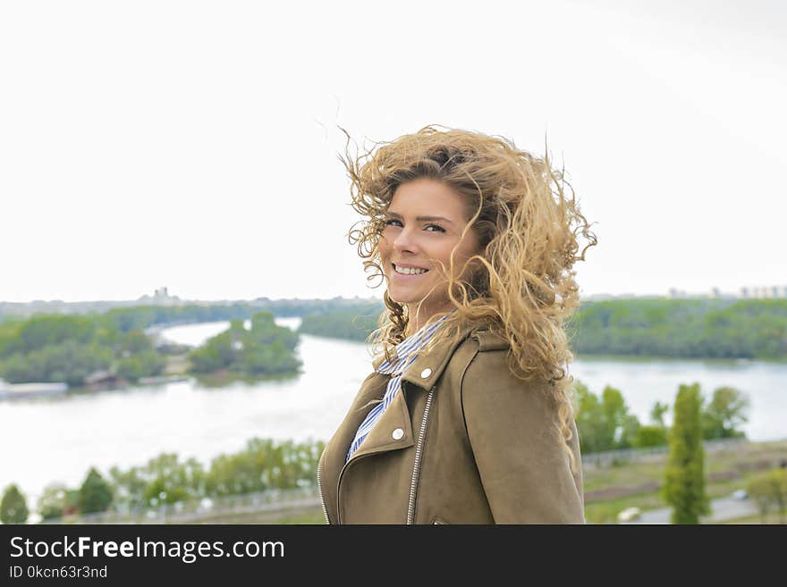 Woman Wearing Brown Coat Smiling