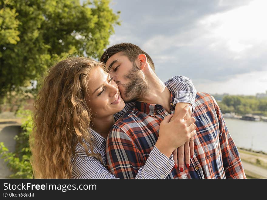 Man Kissing Woman