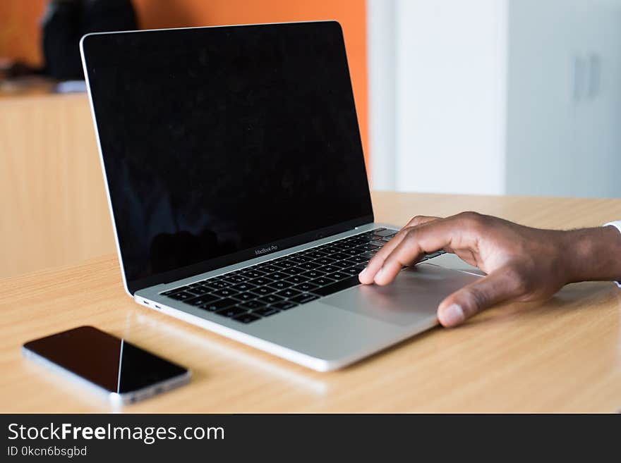 Person&#x27;s Hand on Macbook Pro