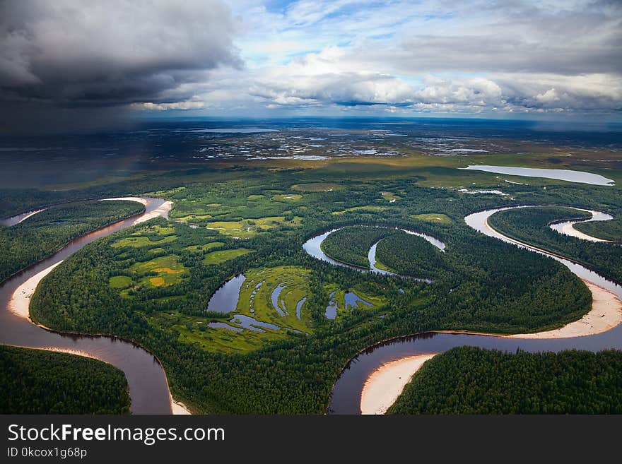 Aerial view of the river executing the loop during the cloudy day of autumn. Aerial view of the river executing the loop during the cloudy day of autumn.