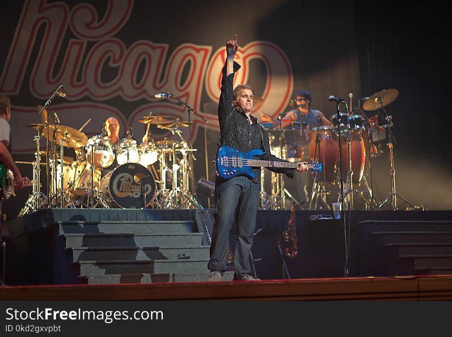 Man Holding Electric Guitar on Stage