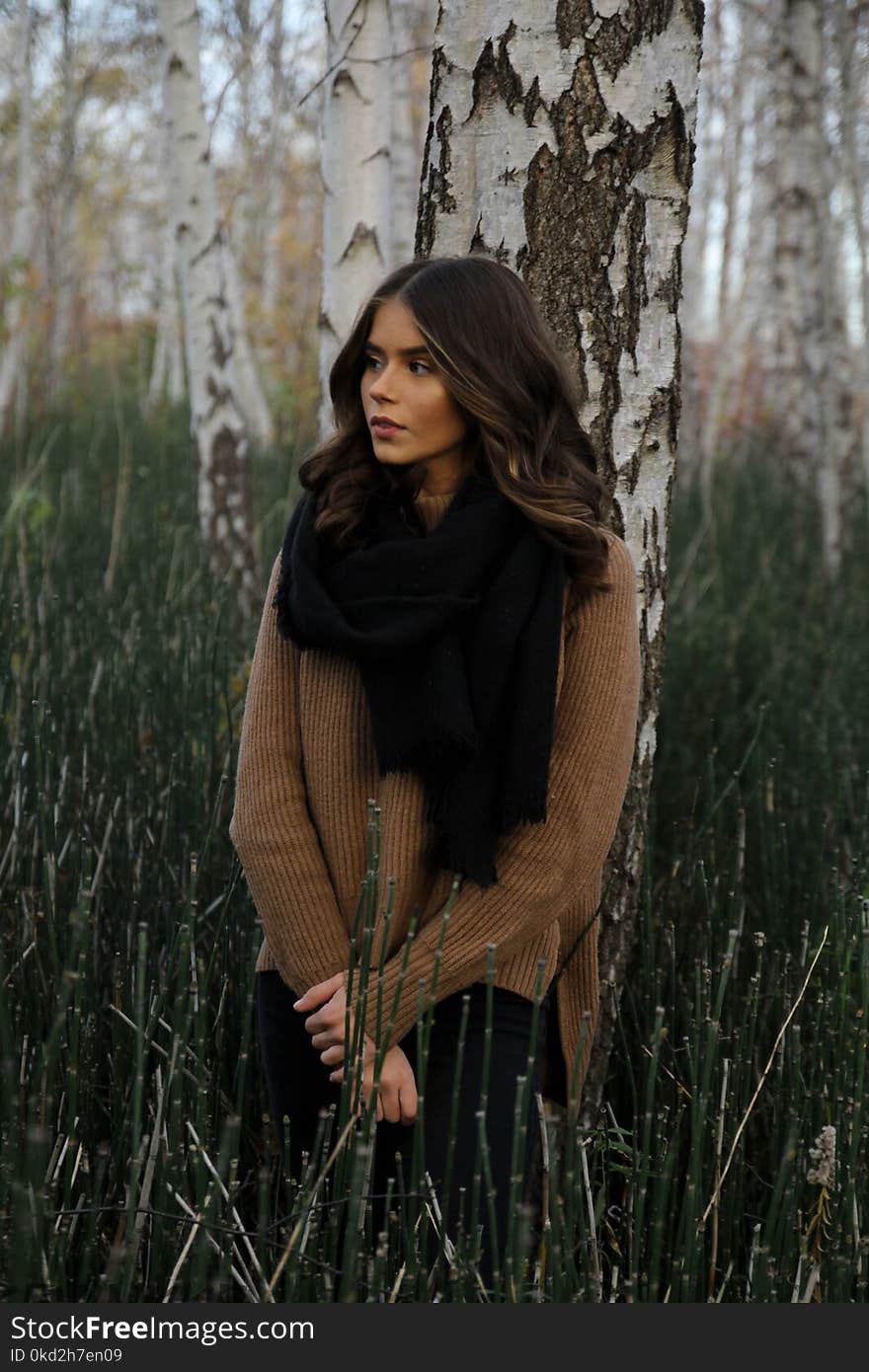 Woman Leaning on Tree