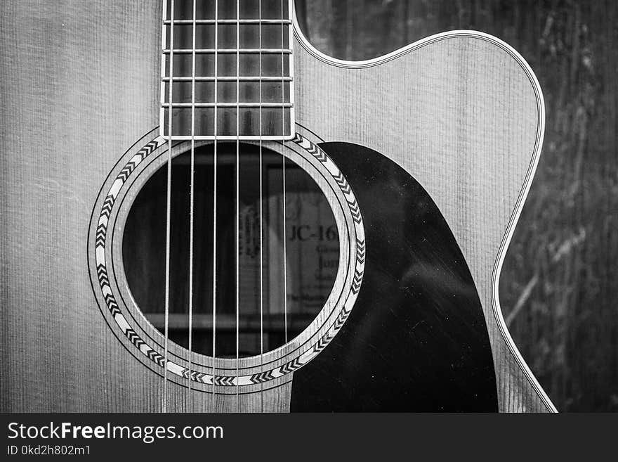 Grayscale Photo of Cutaway Acoustic Guitar