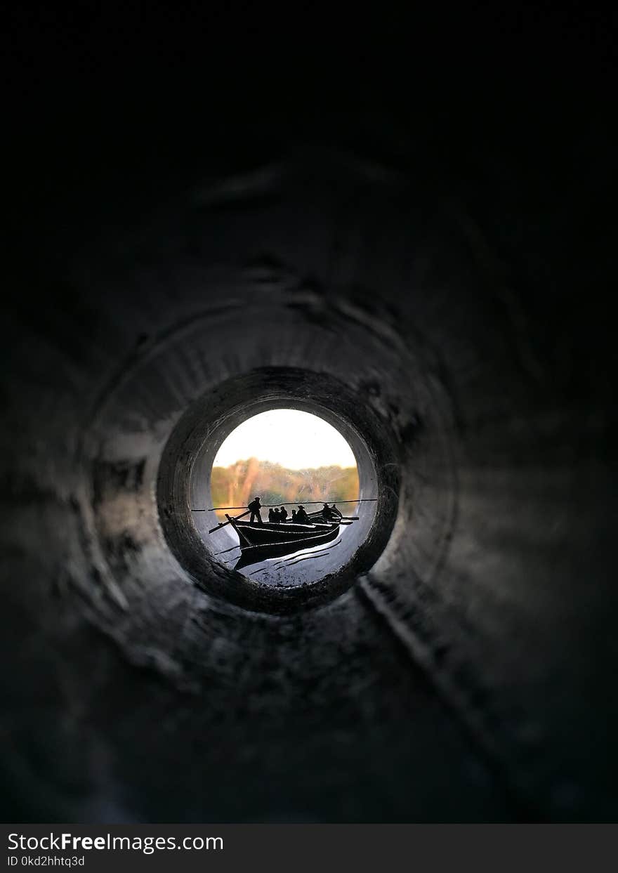 People Riding Canoe Boat View from Inside Pipe