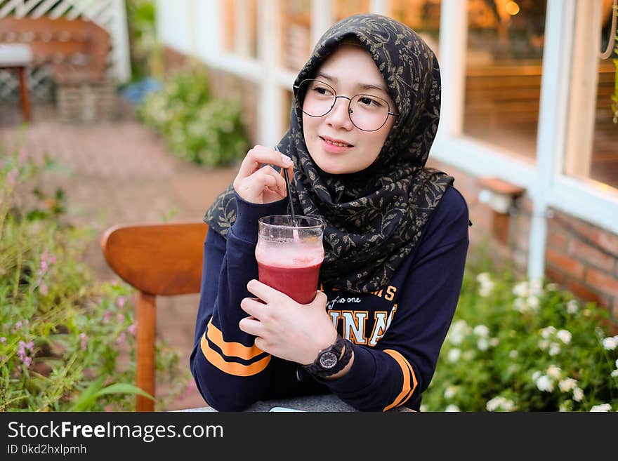 Woman Holding Cup of Red Juice