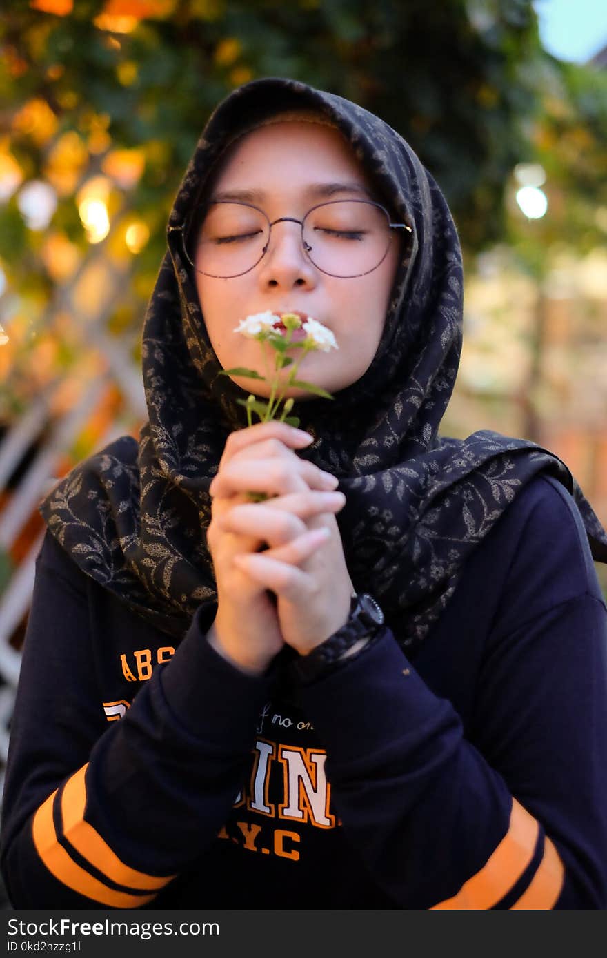 Photo of Girl Smelling White Petaled Flowers