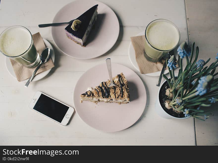 Photo of Sliced Cakes and Milk tea Near Plant