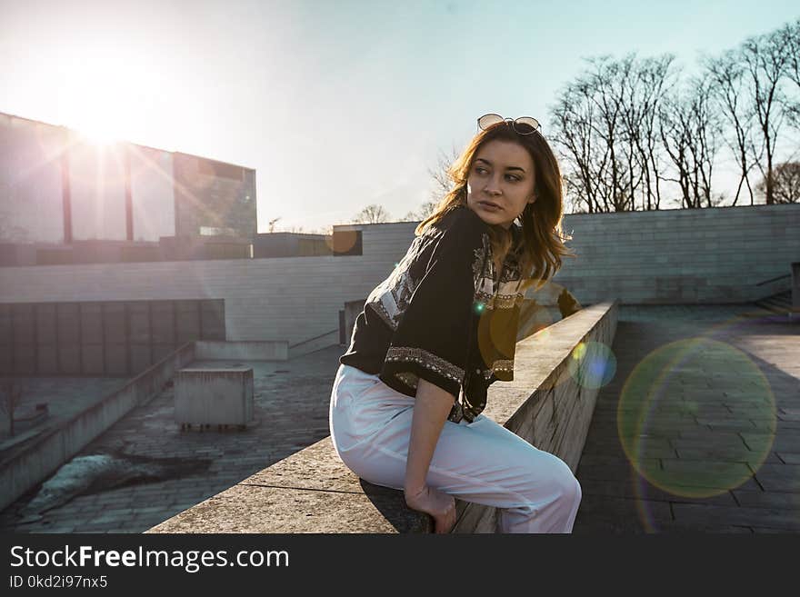 Woman in Black Top and White Pants