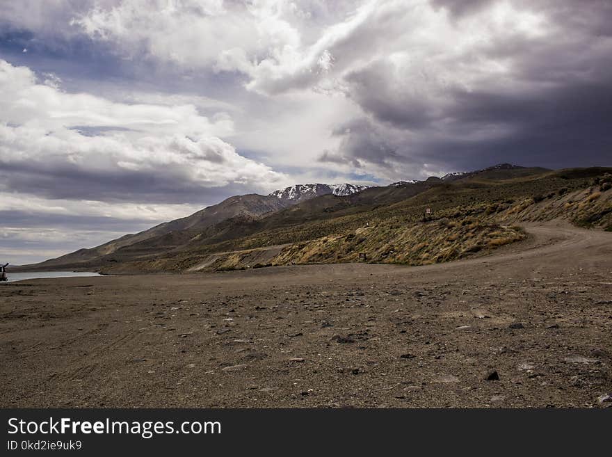 Photography of Mountains Under Cloudy Sky