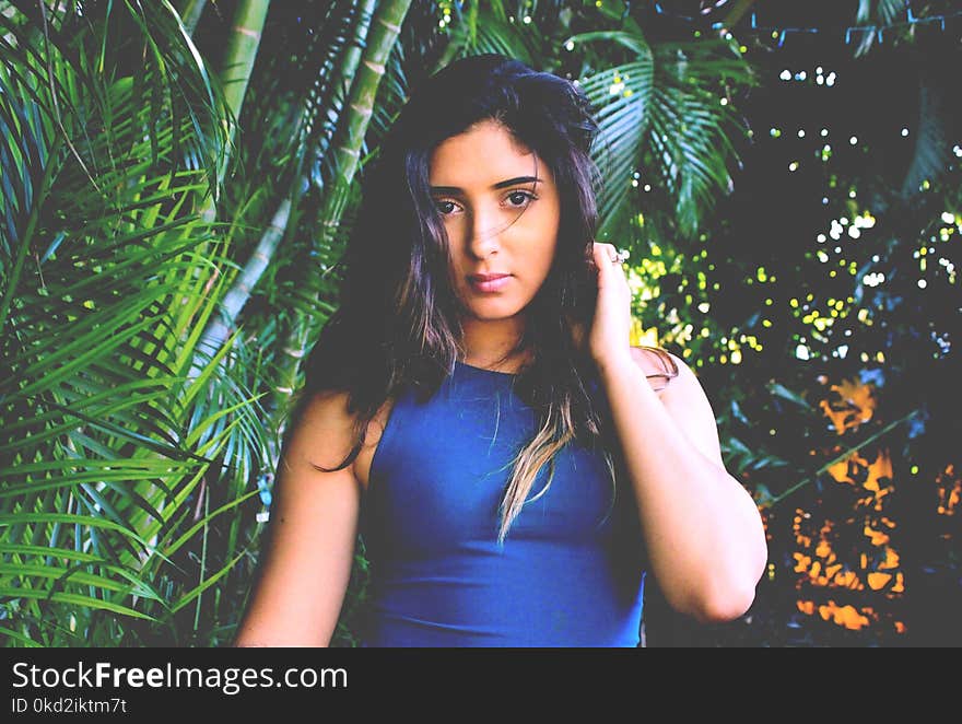 Photo of Woman in Blue Sleeveless Top