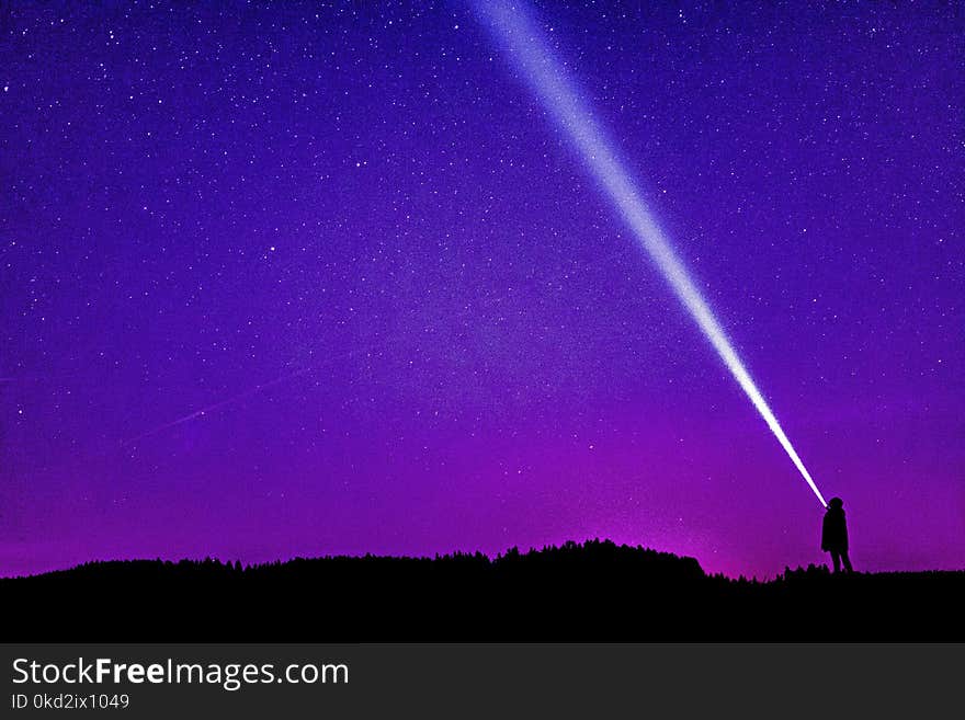 Silhouette of Person Under Blue and Purple Sky