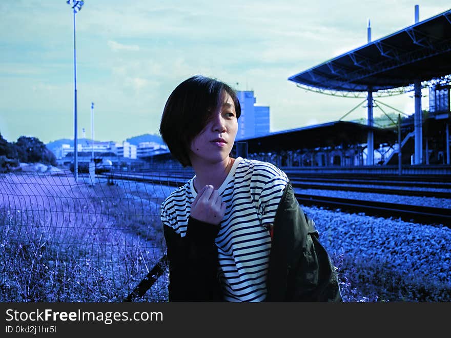 Lady in White Pinstripe Scoop-neck Shirt and Black Jacket