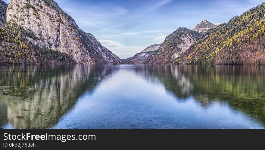 Photograph of Mountain With Plants and Body of Water