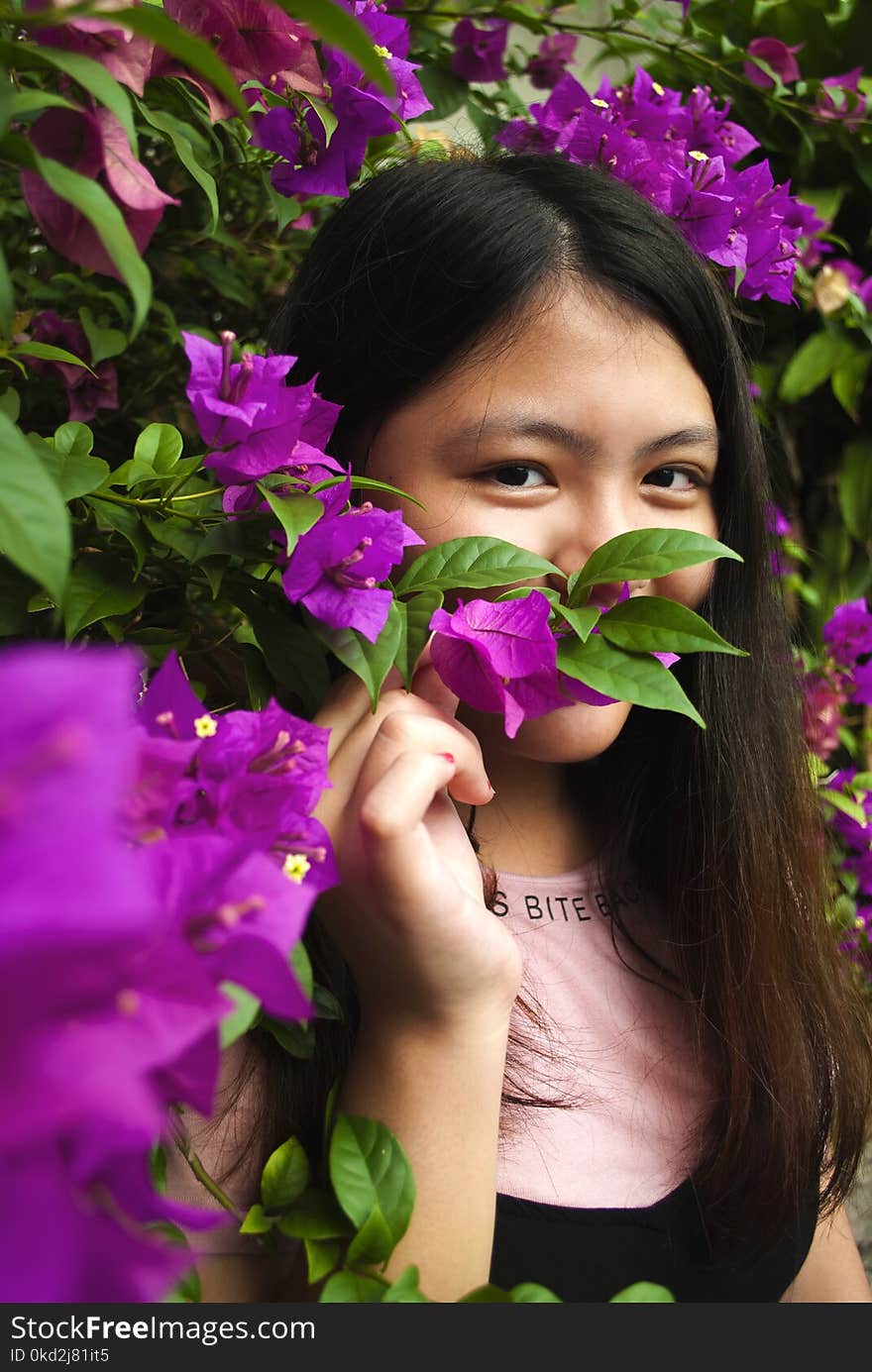 Woman Wearing Pink and Black Shirt Near Purple Petaled Flowers at Daytime