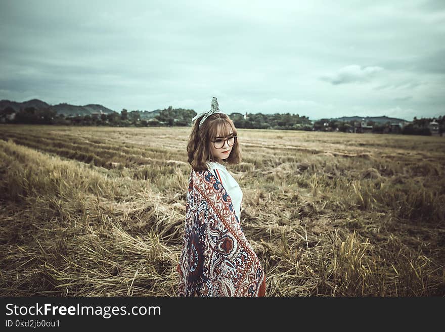 Woman in Brown and Black Floral Scarf