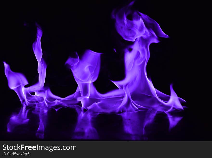 Beautiful fire purple flames on a black background. Beautiful fire purple flames on a black background.