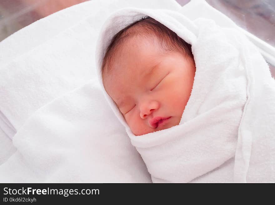 Cute newborn asian baby girl sleeping