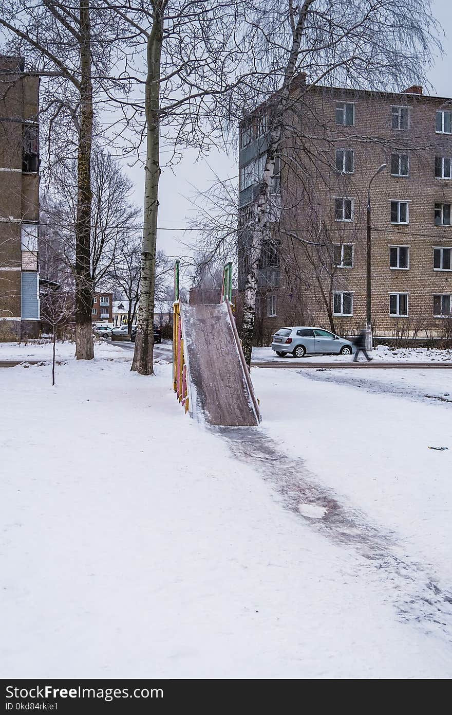 Wooden children`s slide on the playground in the winter. Wooden children`s slide on the playground in the winter.