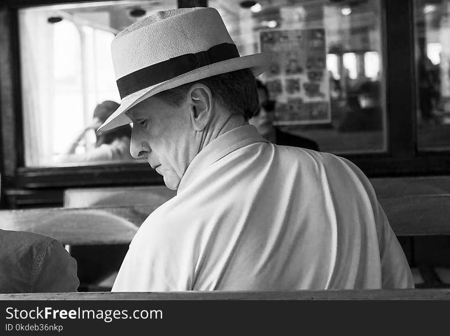 Man Wearing Polo Shirt and Hat in Grayscale Photo