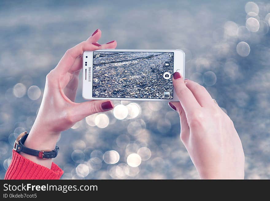 Selective Focus Photo of Person Holds White Samsung Galaxy Note Edge