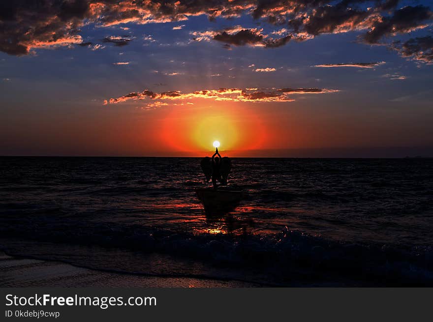 Silhouette Photography of Three People Pointing the Sun