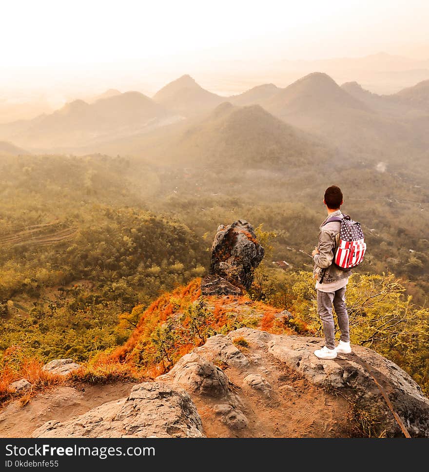 Man Standing on a Mountain Summit