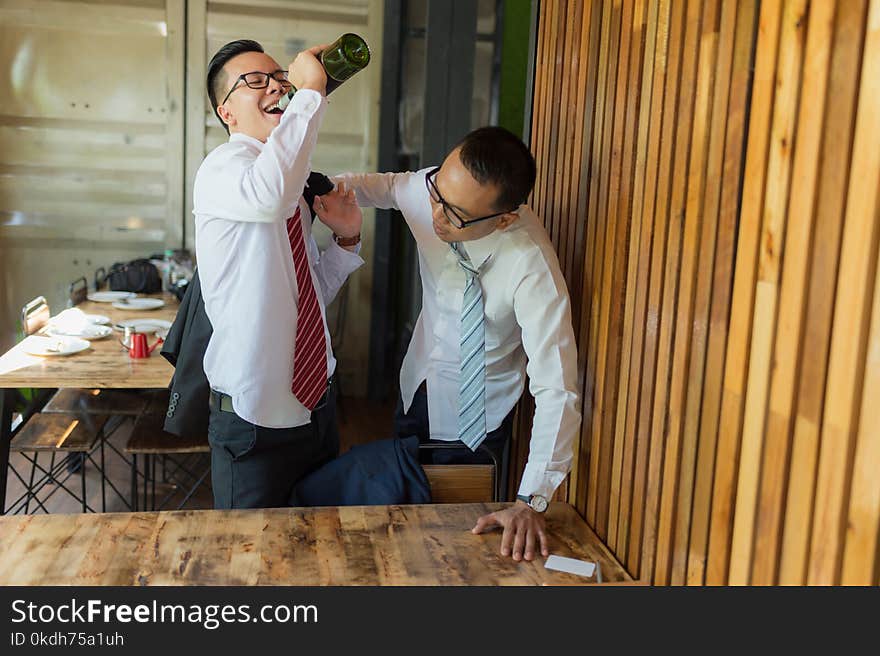 Two businessman is drunk and laughing after drinking hard in restaurant to celebrate the success of work