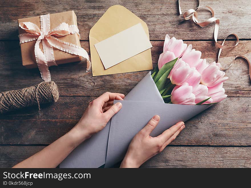 Female florist creating beautiful tulip bouquet