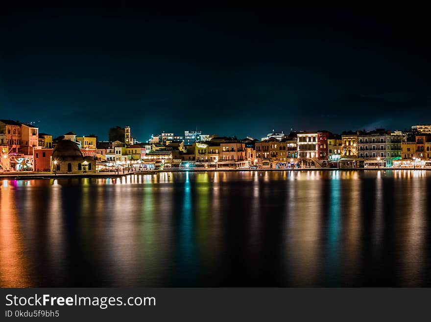 Cityscape Near Body of Water during Nighttime