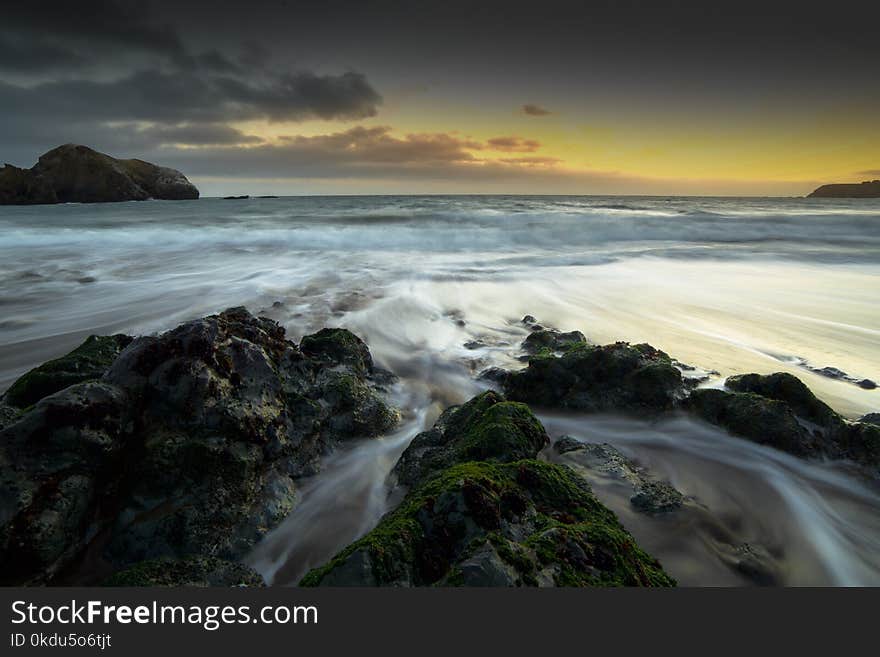 Rocks on Seashore during Golden Hour