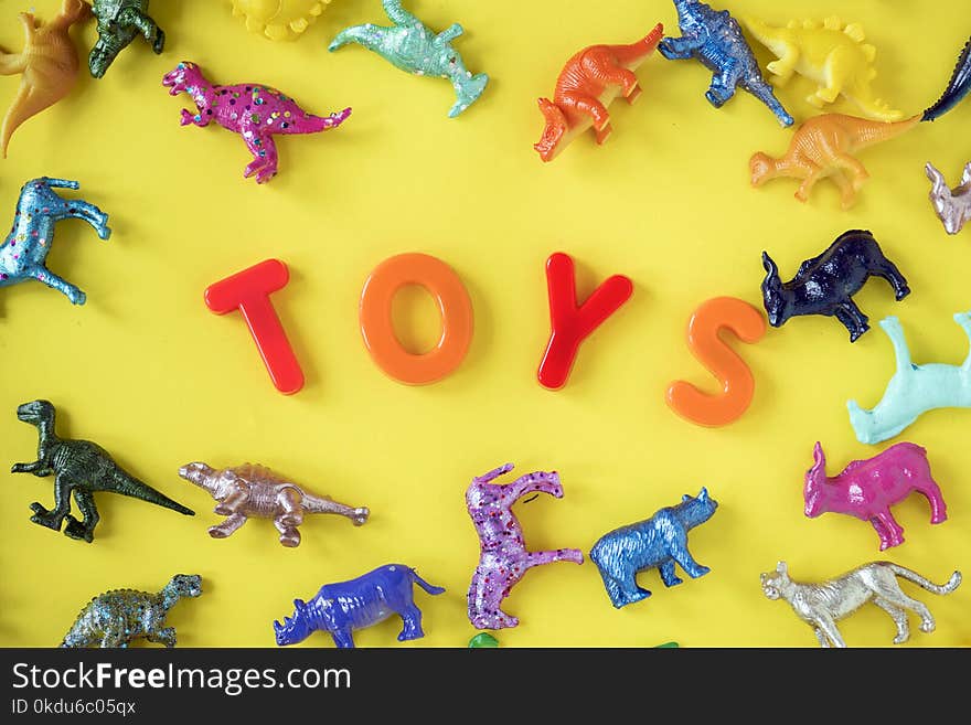 Assorted Plastic Toy on Yellow Surface