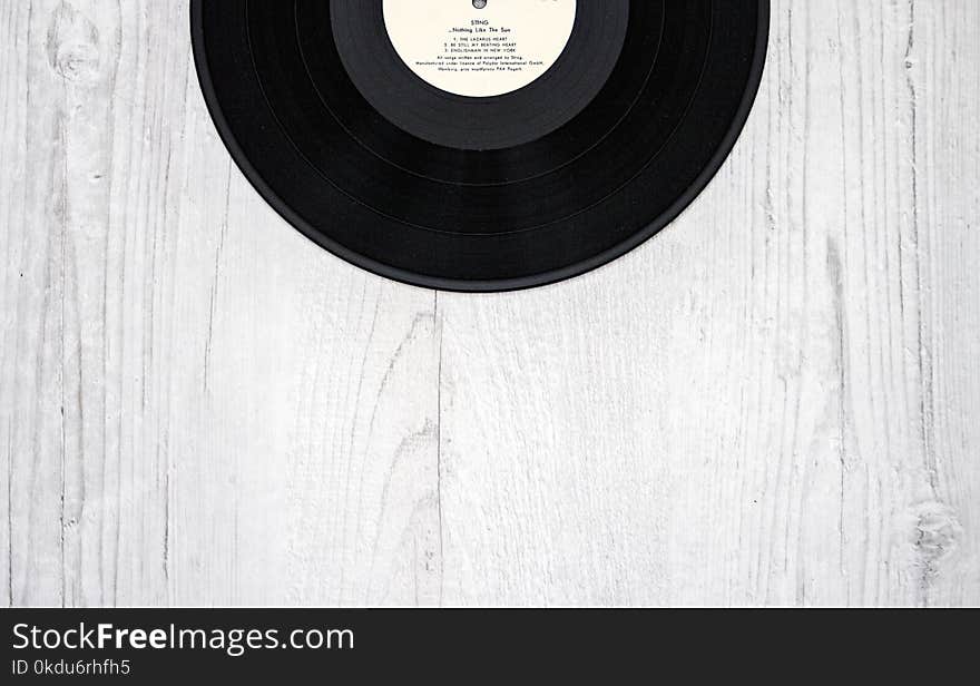 Black Vinyl Record on Wooden Surface