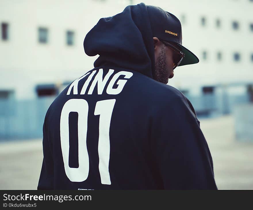 Man Wearing Black King 01-printed Hoodie and Flat Brim Cap