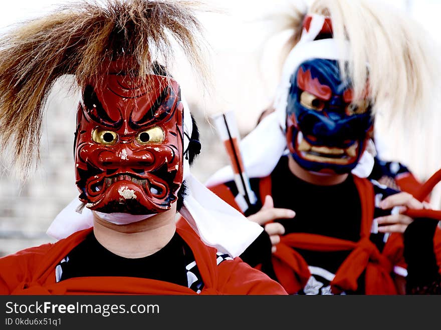 Person&#x27;s Wearing Red and Blue Kabuki Masks