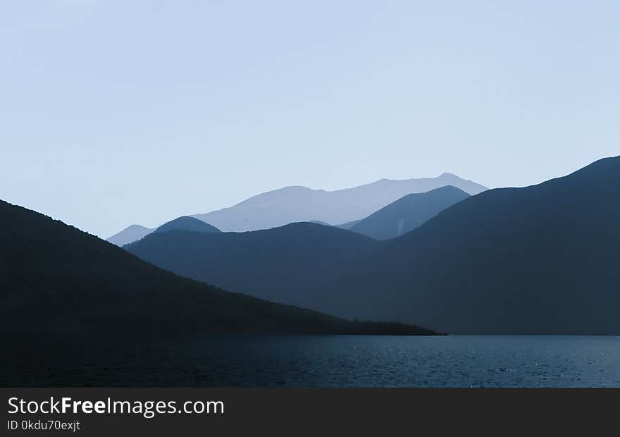 Photo of Mountains Near Body of Water