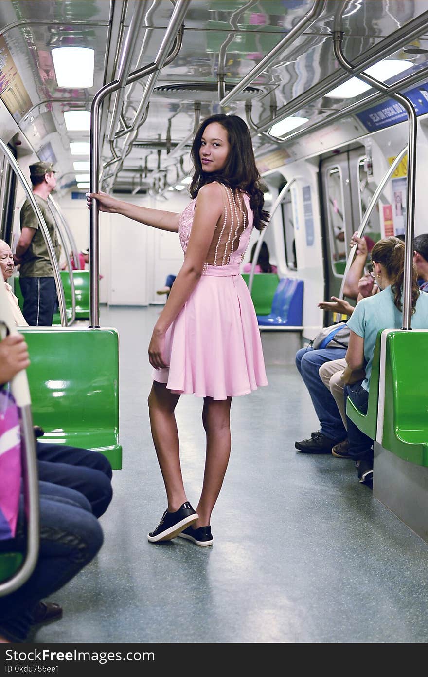 Woman Wearing Pink Sleeveless Dress Inside the Train