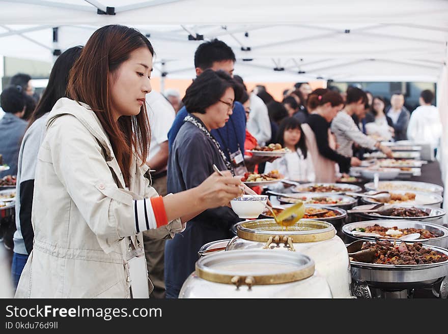 People in Front of Food Containers