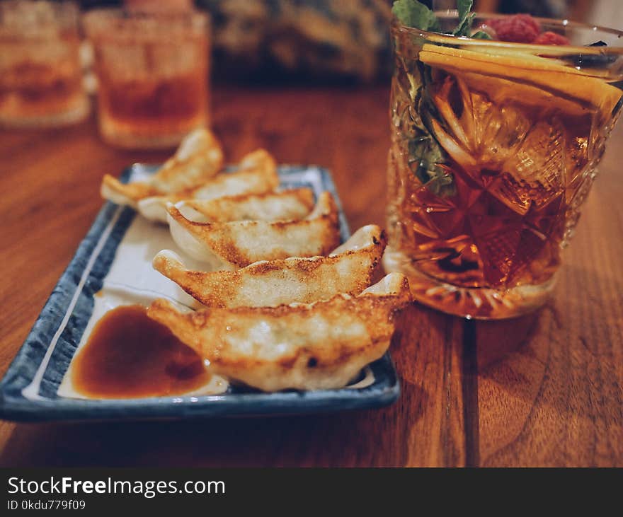 Cooked Breads Platter Beside Drink