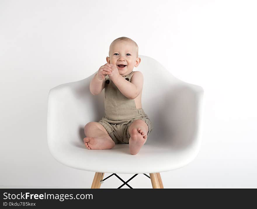 Baby Sitting on White Chair