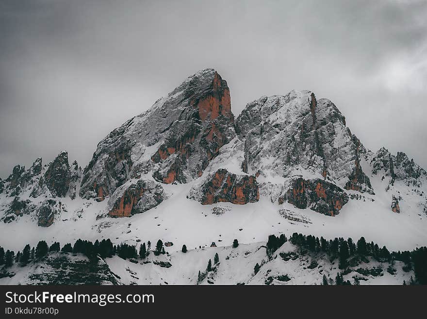 Snow Capped Mountain Under Gray Clouds