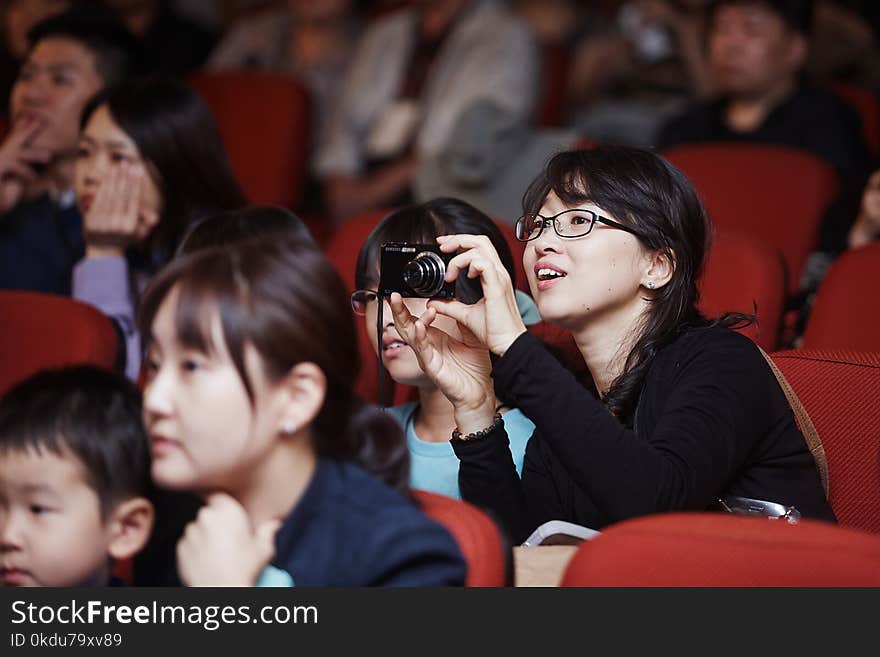 Selective Focus Photography of Woman Wearing Black Jacket Holding Camera