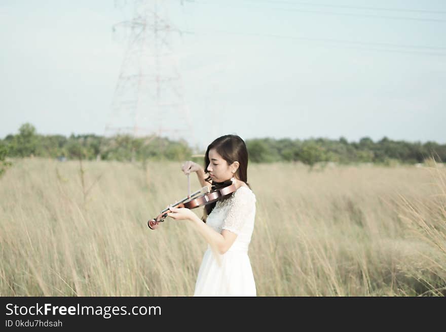 Woman Wearing White Dress Playing Violin