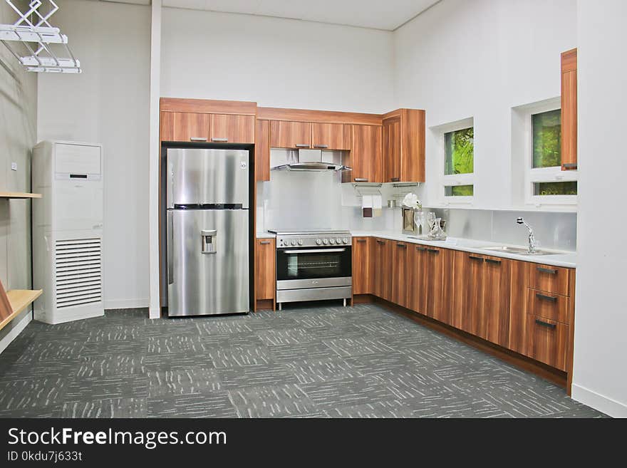 Stainless Steel Top-mount Refrigerator on Gray Carpet